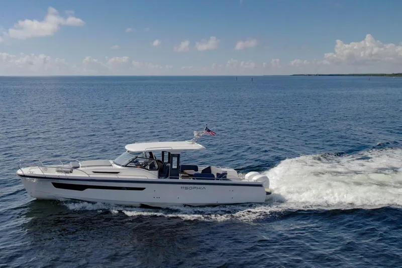 T/t Sophia Yacht Photos Pics 2022 Nimbus T11 boat cruising on open water under a clear blue sky.