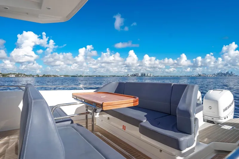 T/t Sophia Yacht Photos Pics 2022 Nimbus T11 boat deck with seating, table, and scenic ocean view.