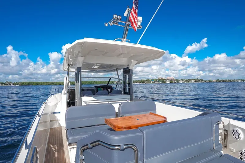 T/t Sophia Yacht Photos Pics 2022 Nimbus T11 boat on calm water, featuring spacious seating and a sleek design.