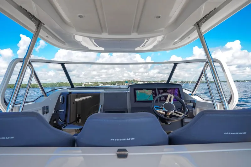 T/t Sophia Yacht Photos Pics Interior view of 2022 Nimbus T11 boat cockpit with navigation screens and steering wheel.