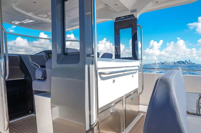 T/t Sophia Yacht Photos Pics Interior of 2022 Nimbus T11 boat with ocean view and city skyline.