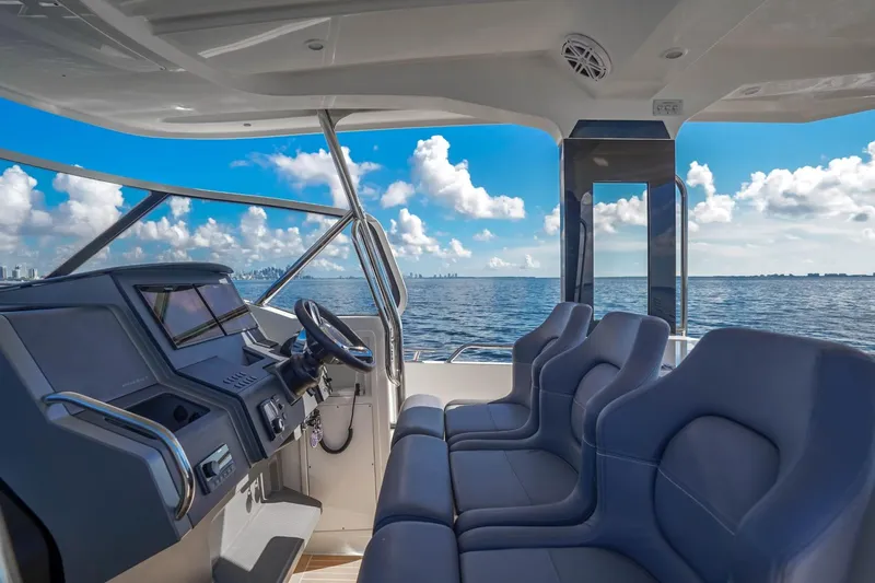 T/t Sophia Yacht Photos Pics Interior view of 2022 Nimbus T11 boat with ocean and skyline in background.