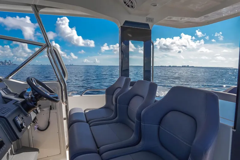 T/t Sophia Yacht Photos Pics 2022 Nimbus T11 boat interior with ocean view, featuring sleek seating and modern controls.