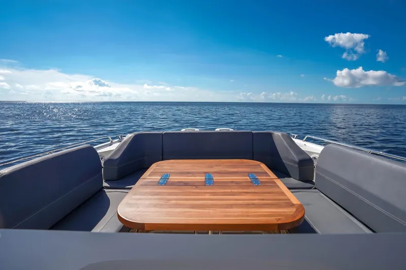 T/t Sophia Yacht Photos Pics Luxurious Nimbus T11 boat interior with wooden table, ocean view, and clear blue sky.
