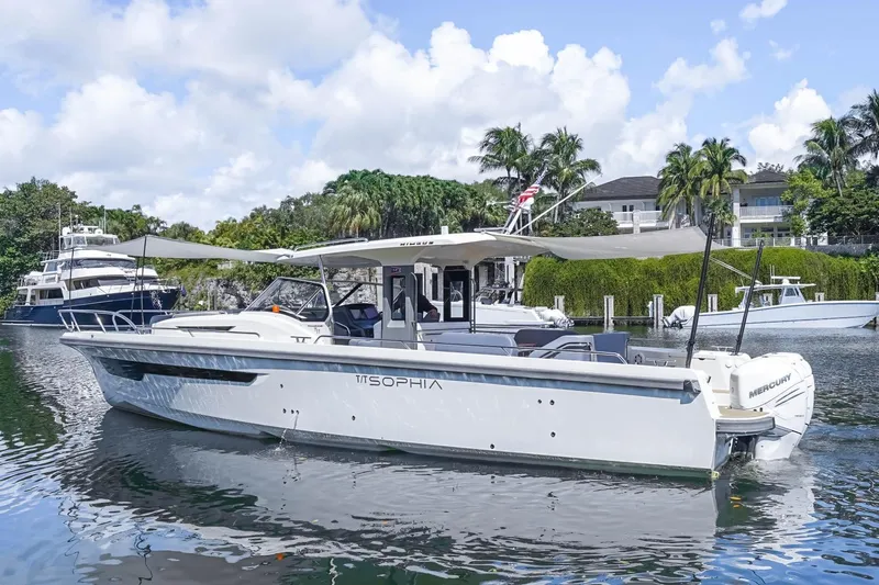T/t Sophia Yacht Photos Pics 2022 Nimbus T11 boat docked in a scenic marina with palm trees.