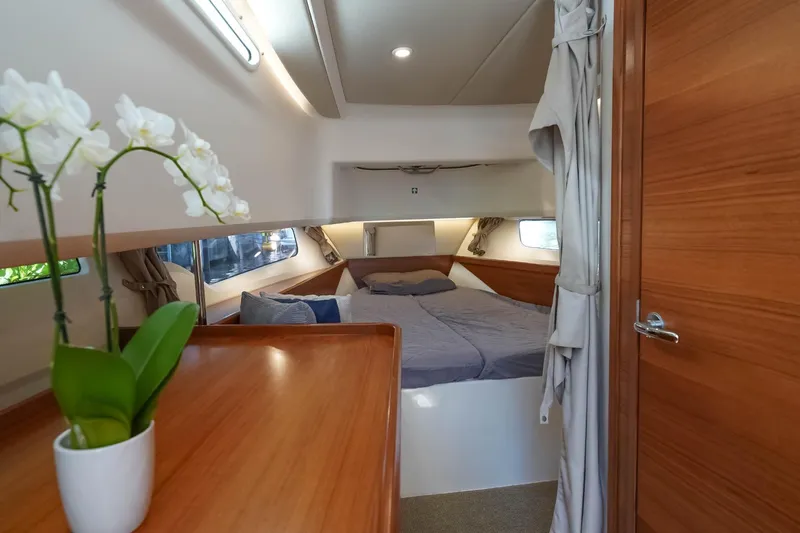 T/t Sophia Yacht Photos Pics Luxurious 2022 Nimbus T11 yacht cabin with cozy bed and elegant wooden interior.