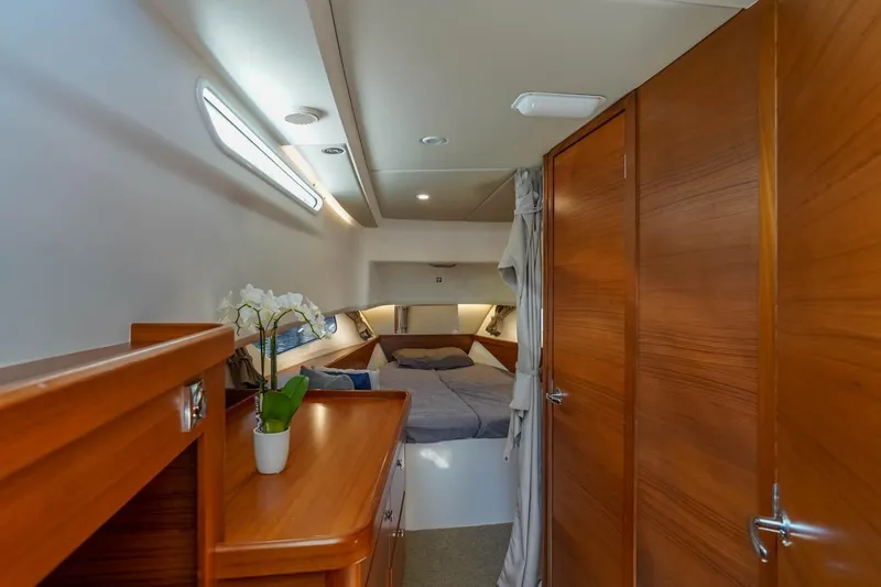 T/t Sophia Yacht Photos Pics Luxurious cabin interior of 2022 Nimbus T11 yacht with wooden finishes and cozy bed.