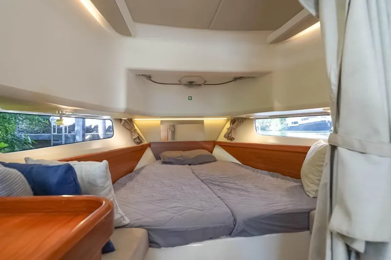 T/t Sophia Yacht Photos Pics Luxurious interior cabin of 2022 Nimbus T11 boat with cozy bedding and elegant wood accents.