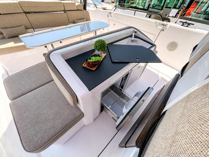  Yacht Photos Pics 2024 Axopar 45 ST BRABUS Trim Mediterrana interior with seating and table setup.