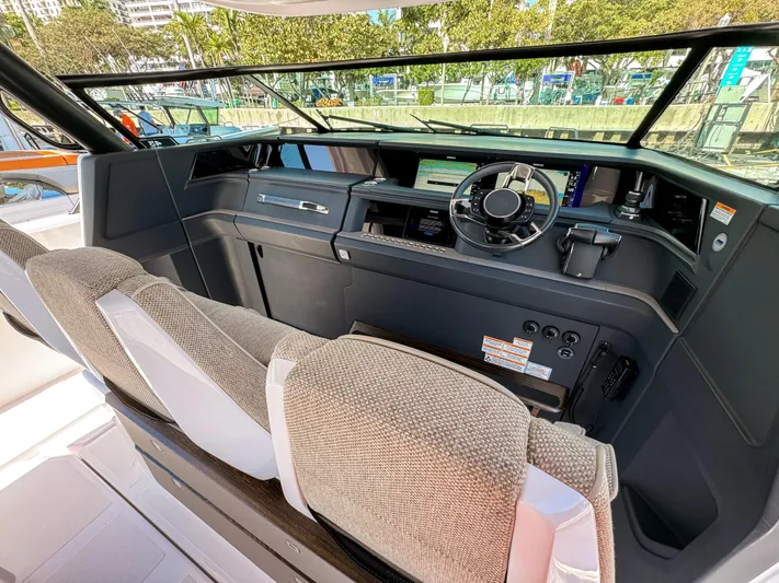  Yacht Photos Pics 2024 Axopar 45 ST BRABUS Trim Mediterrana cockpit with modern dashboard and steering wheel.