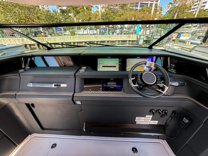  Yacht Photos Pics 2024 Axopar 45 ST BRABUS Trim Mediterrana helm with modern controls and sleek dashboard design.