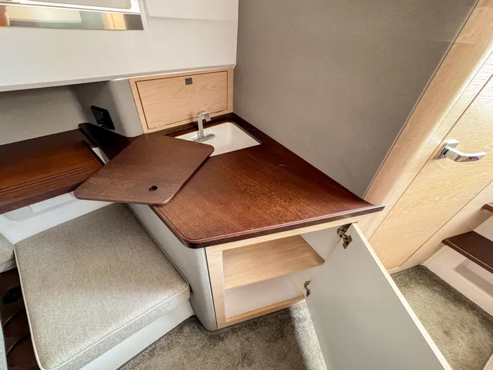  Yacht Photos Pics 2024 Axopar 45 ST BRABUS Trim Mediterrana interior with wooden cabinetry and sink.