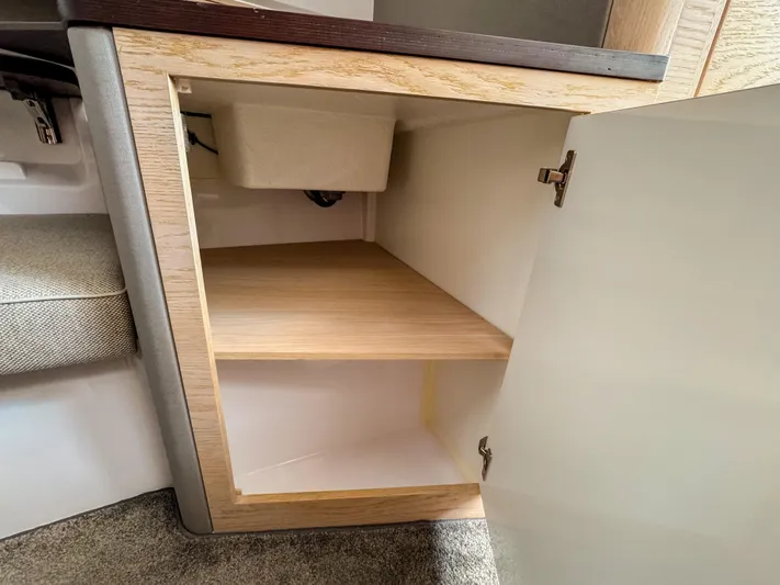  Yacht Photos Pics Open cabinet in 2024 Axopar 45 ST BRABUS Trim Mediterrana, showcasing interior shelving.