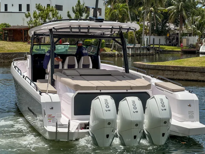  Yacht Photos Pics 2024 Axopar 45 ST BRABUS Trim Mediterrana boat with triple V8 engines in a canal setting.