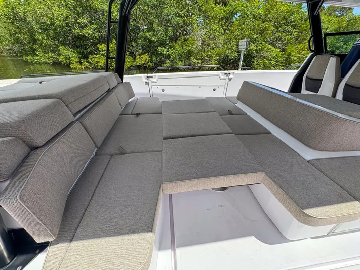  Yacht Photos Pics 2024 Axopar 45 ST BRABUS Trim Mediterrana interior with spacious seating and lush greenery backdrop.