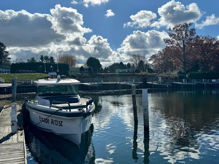 Escape Artist Yacht Photos Pics 2020 Axopar 37 Cross Cabin BRABUS boat docked on a sunny day with clouds.