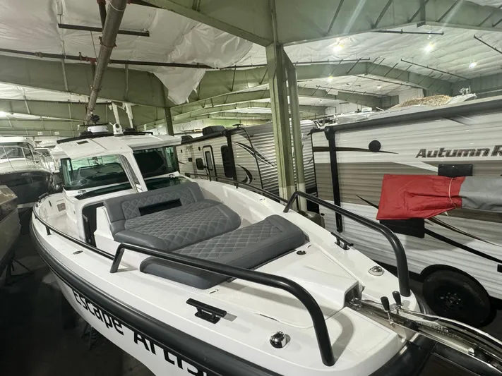 Escape Artist Yacht Photos Pics 2020 Axopar 37 Cross Cabin BRABUS in storage, featuring sleek design and spacious deck.