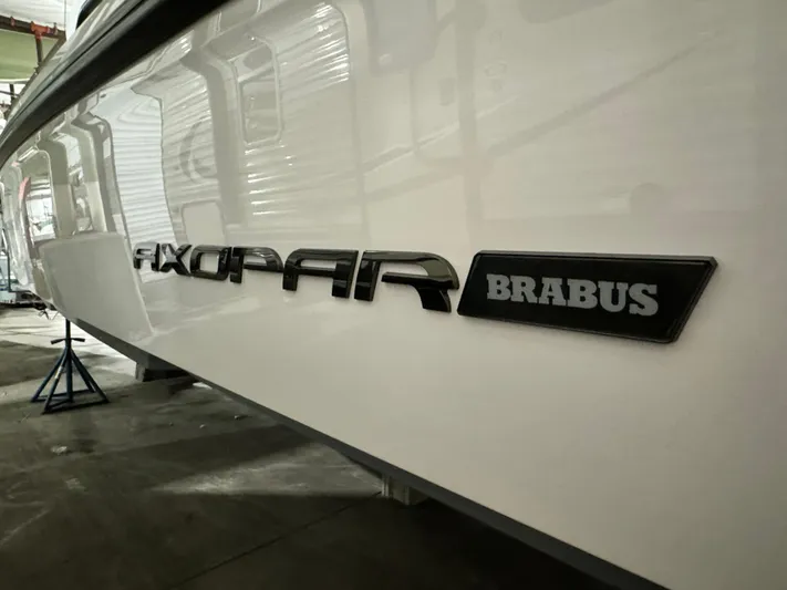 Escape Artist Yacht Photos Pics 2020 Axopar 37 Cross Cabin BRABUS boat side view in a garage.