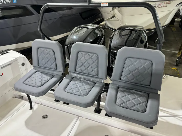 Escape Artist Yacht Photos Pics Three gray cushioned seats on a 2020 Axopar 37 Cross Cabin BRABUS boat.