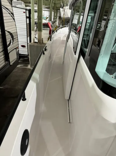 Escape Artist Yacht Photos Pics 2020 Axopar 37 Cross Cabin BRABUS, side deck view in a storage facility.