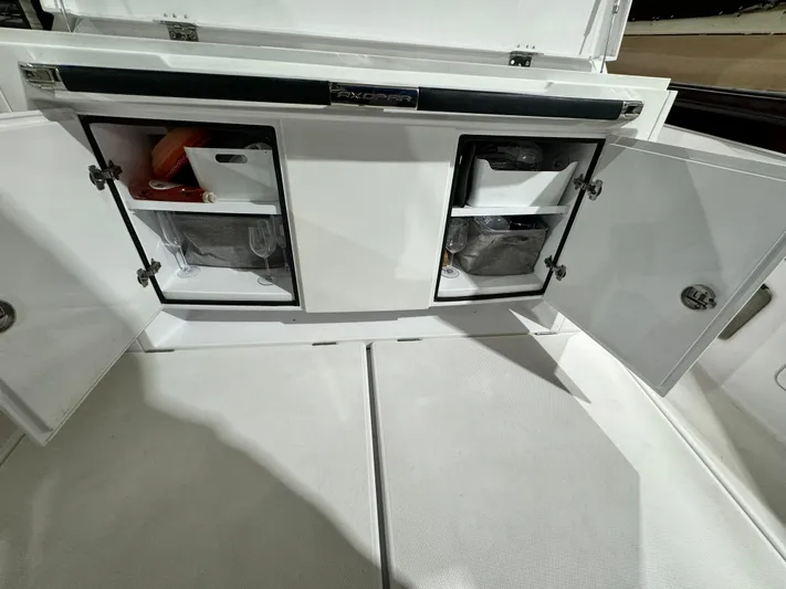 Escape Artist Yacht Photos Pics Storage compartments on a 2020 Axopar 37 Cross Cabin BRABUS boat, open and organized.
