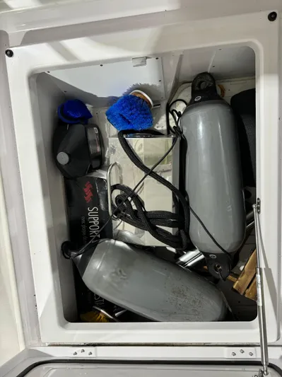 Escape Artist Yacht Photos Pics Storage compartment of 2020 Axopar 37 Cross Cabin BRABUS with boat equipment and accessories.