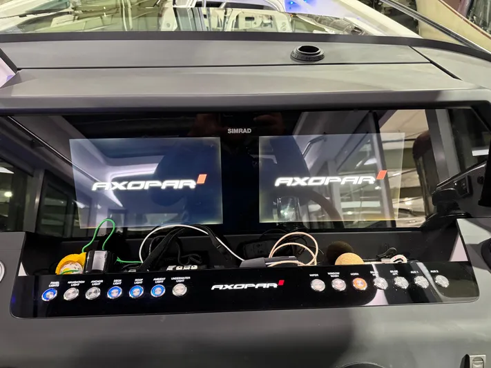 Escape Artist Yacht Photos Pics Control panel of 2020 Axopar 37 Cross Cabin BRABUS with dual screens and buttons.