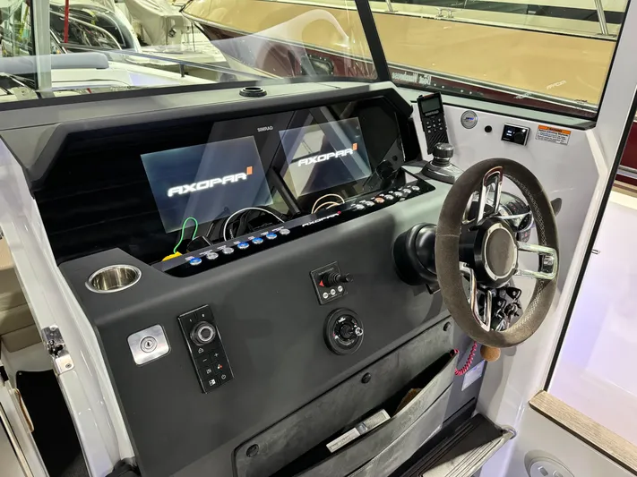 Escape Artist Yacht Photos Pics 2020 Axopar 37 Cross Cabin BRABUS helm with modern controls and dual displays.