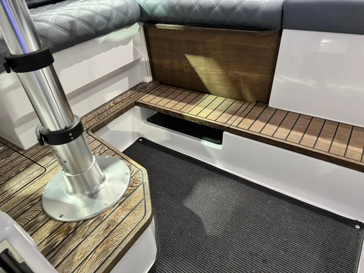 Escape Artist Yacht Photos Pics Interior of 2020 Axopar 37 Cross Cabin BRABUS with wood accents and cushioned seating.
