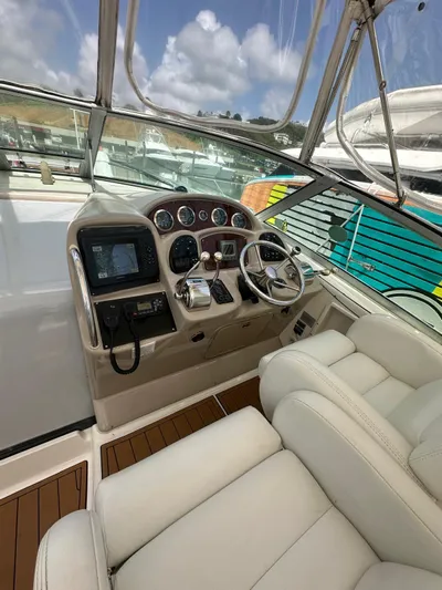  Yacht Photos Pics 2004 Sea Ray 340 Sundancer helm with modern controls and plush seating.