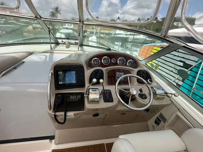  Yacht Photos Pics Cockpit of 2004 Sea Ray 340 Sundancer with navigation instruments and steering wheel.