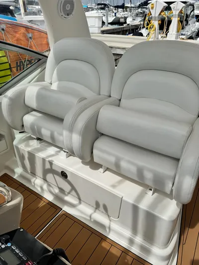  Yacht Photos Pics 2004 Sea Ray 340 Sundancer cockpit with plush white seating and teak flooring.