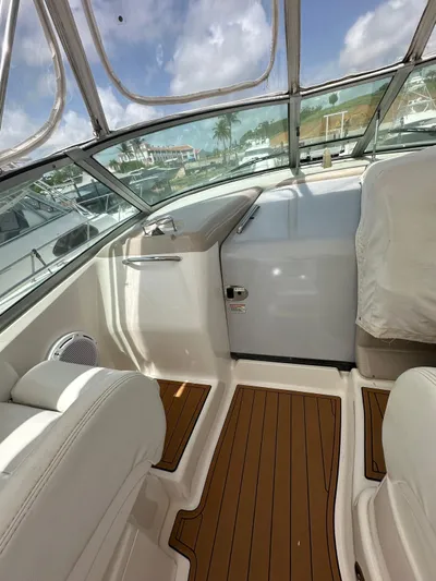  Yacht Photos Pics Interior of 2004 Sea Ray 340 Sundancer with wood flooring and white seating.