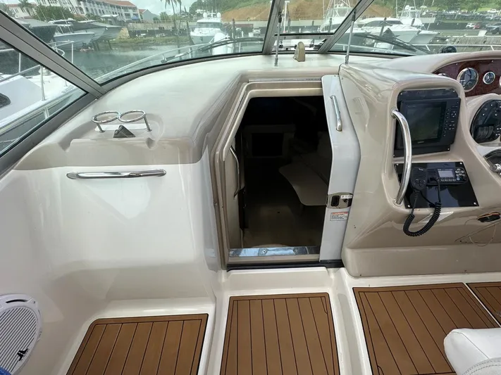  Yacht Photos Pics 2004 Sea Ray 340 Sundancer cockpit with wood flooring and navigation equipment.