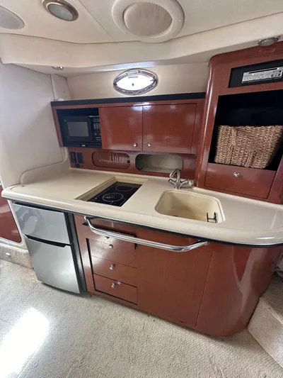  Yacht Photos Pics 2004 Sea Ray 340 Sundancer yacht kitchen with sink, stove, and microwave.