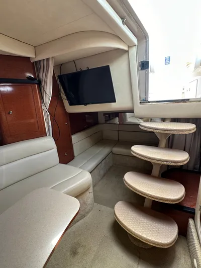  Yacht Photos Pics Interior of 2004 Sea Ray 340 Sundancer with TV, seating, and curved stairs.