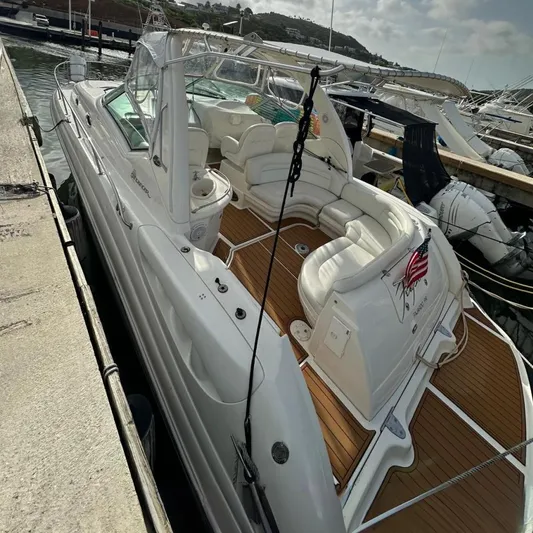 Yacht Photos Pics 2004 Sea Ray 340 Sundancer yacht docked at marina under cloudy sky.