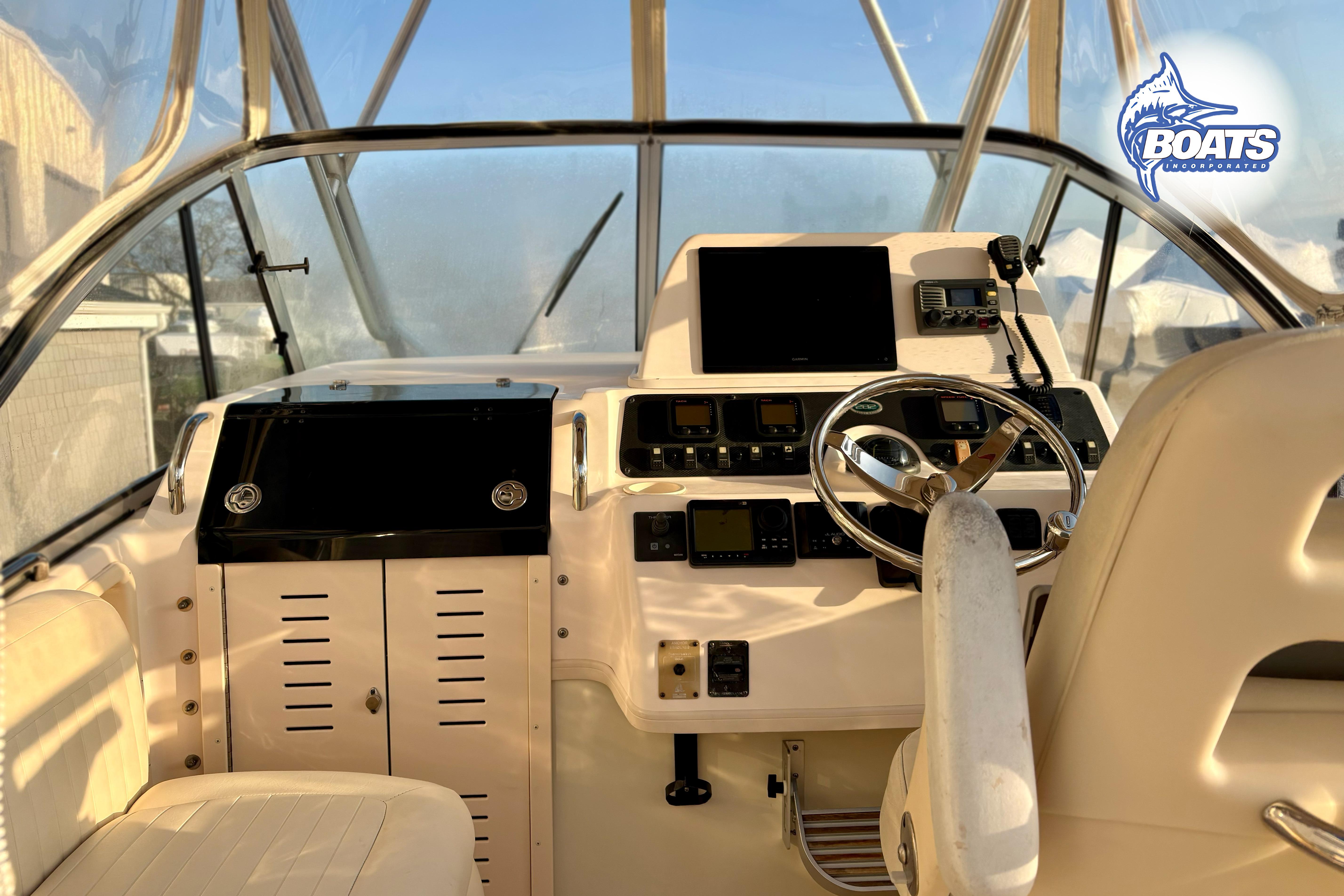 2008 Grady-White Sailfish 282 helm with steering wheel and navigation equipment.