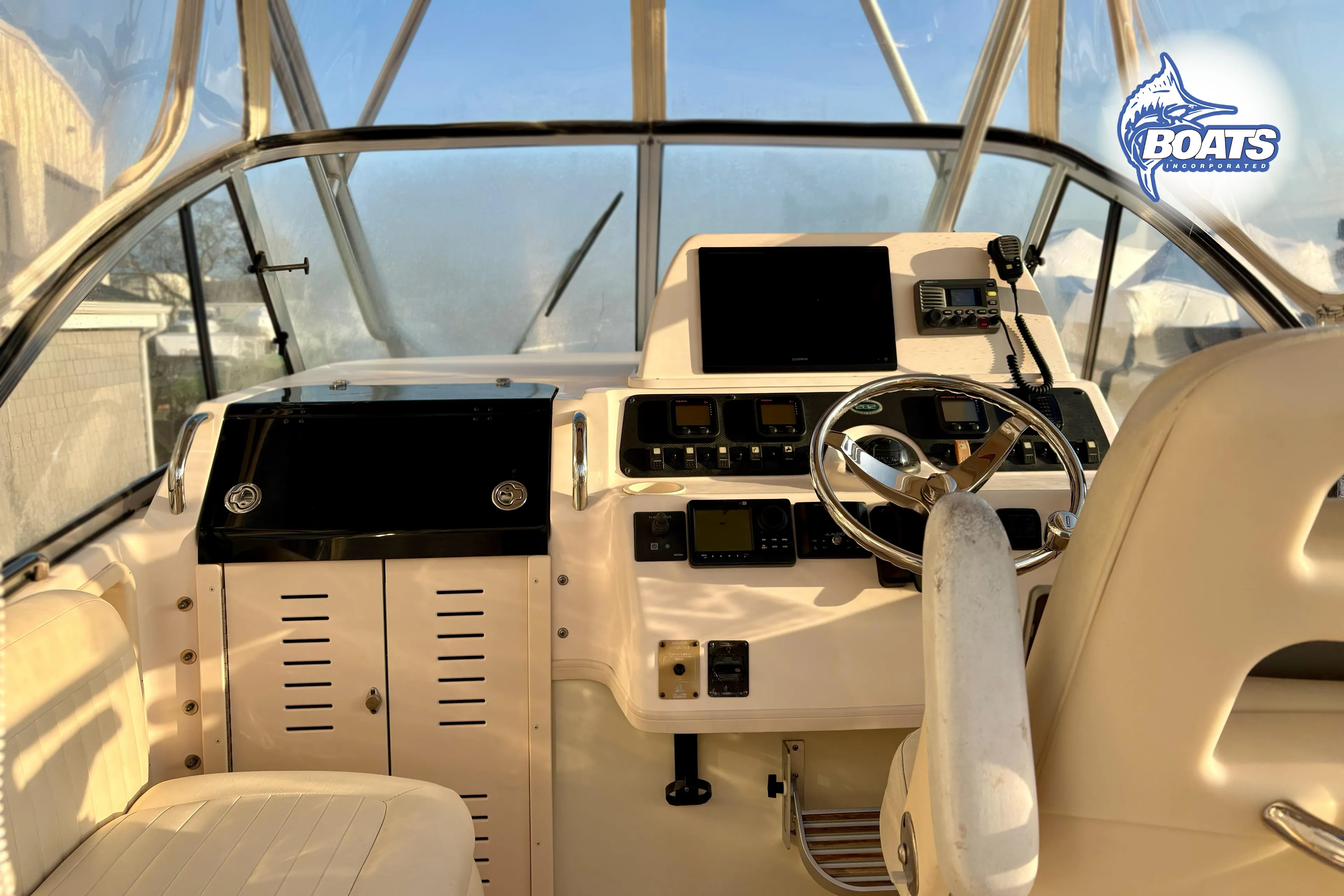 2008 Grady-White Sailfish 282 helm with steering wheel and navigation equipment.