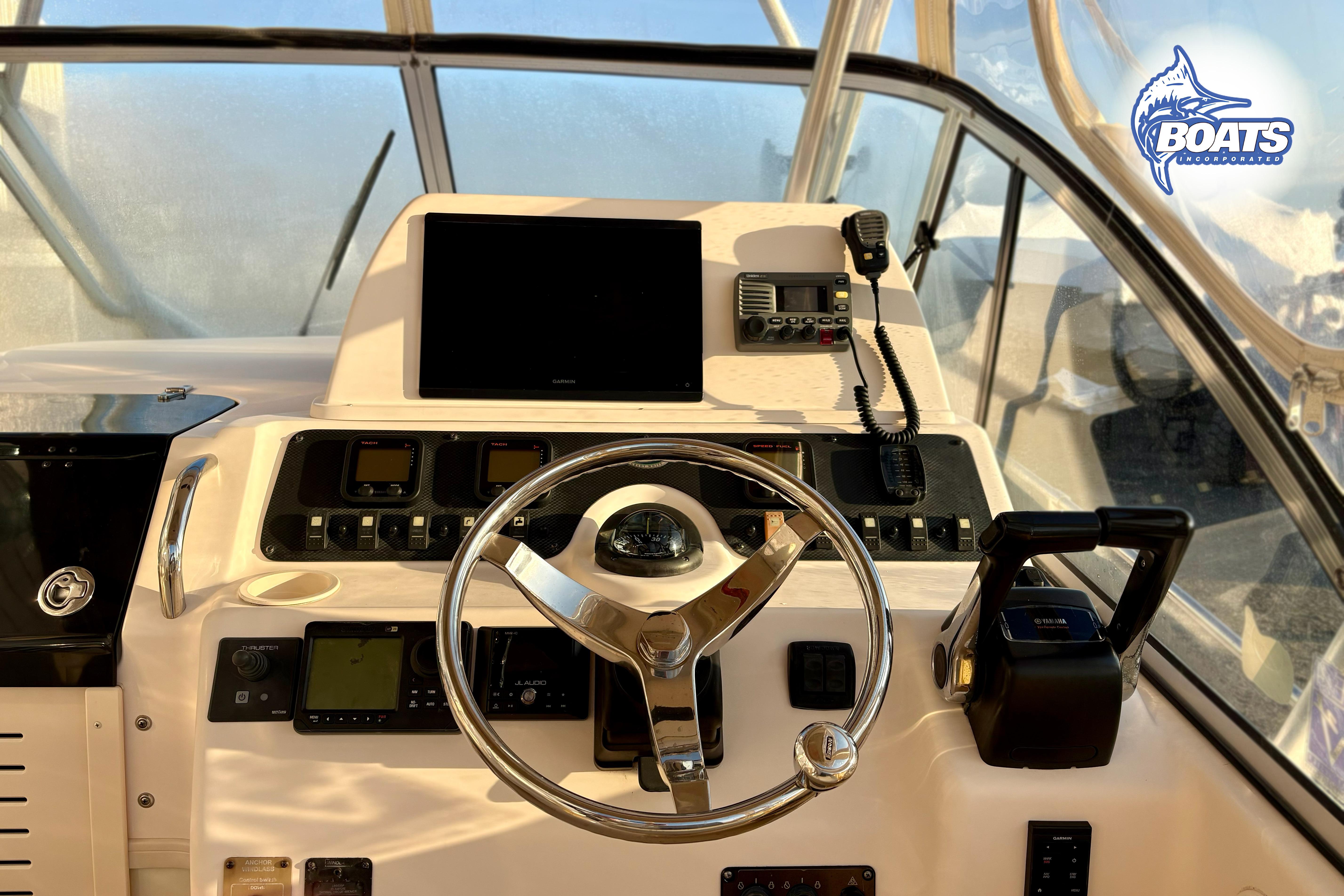 2008 Grady-White Sailfish 282 helm with steering wheel, controls, and navigation equipment.