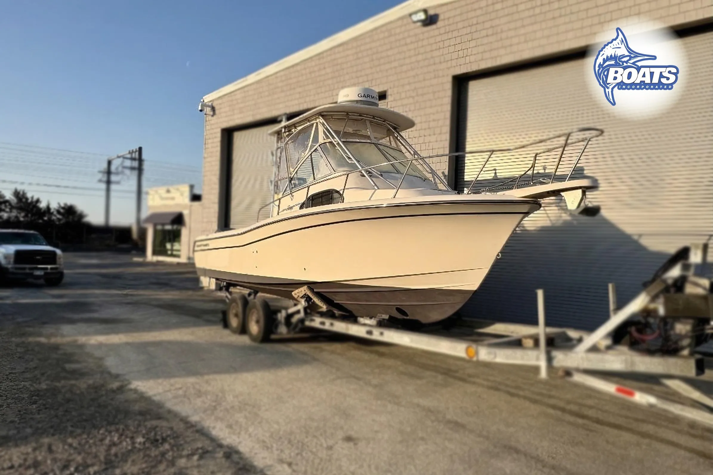 2008 Grady-White Sailfish 282 boat on trailer outside a warehouse.