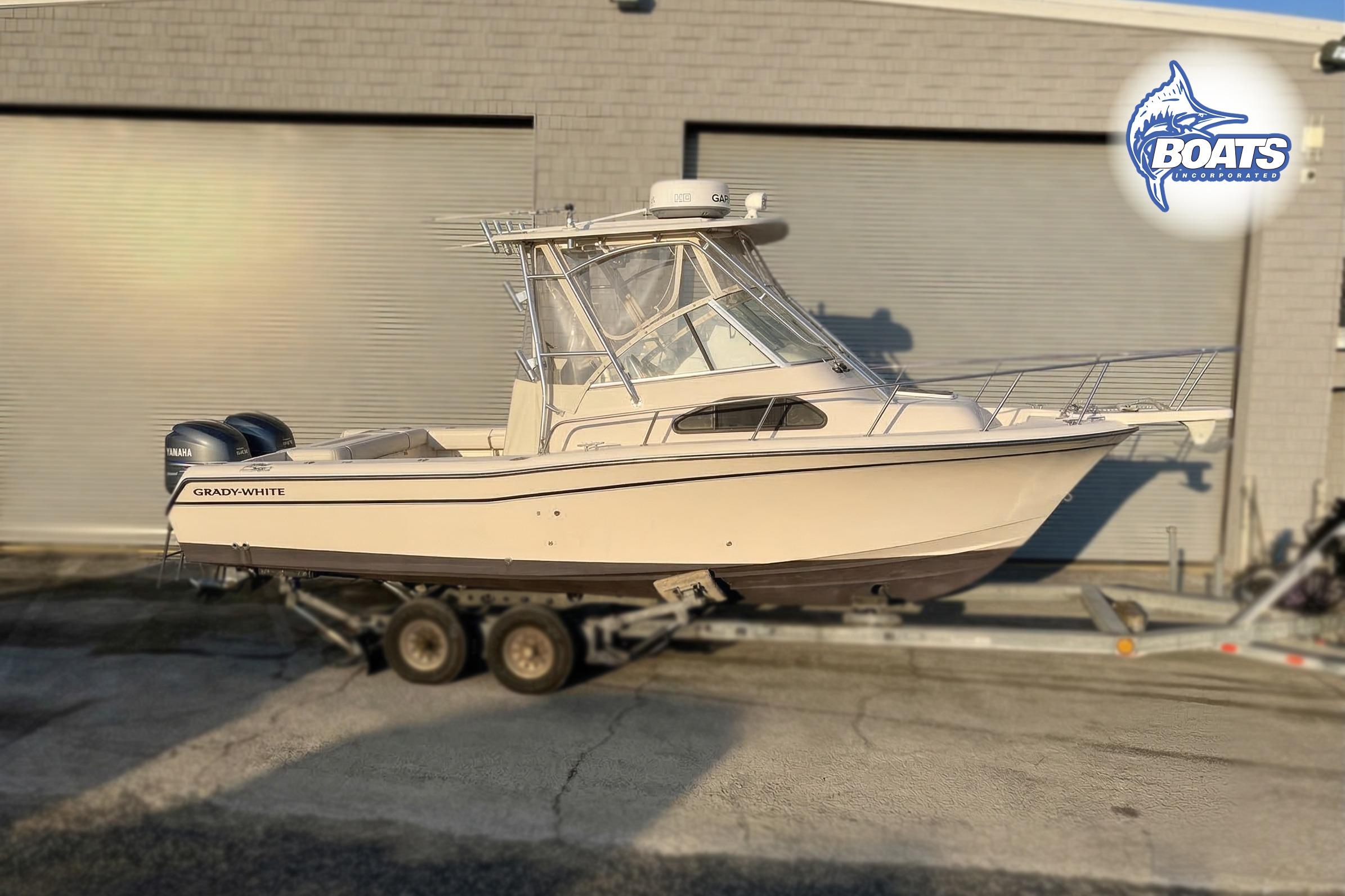 2008 Grady-White Sailfish 282 boat on trailer, parked outside a building.