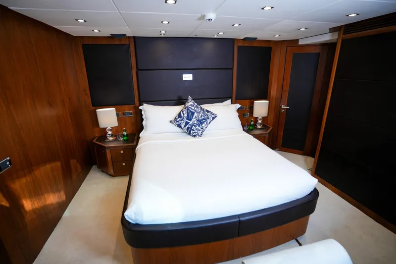  Yacht Photos Pics Luxurious Sunseeker 40M 2010 yacht bedroom with elegant wood paneling and modern decor.