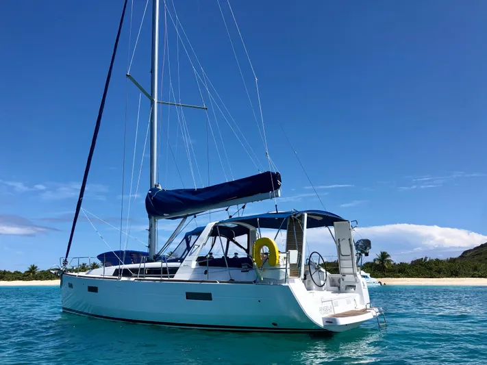 Angela Yacht Photos Pics 2013 Beneteau Oceanis 41 sailboat anchored near tropical beach under clear blue sky.