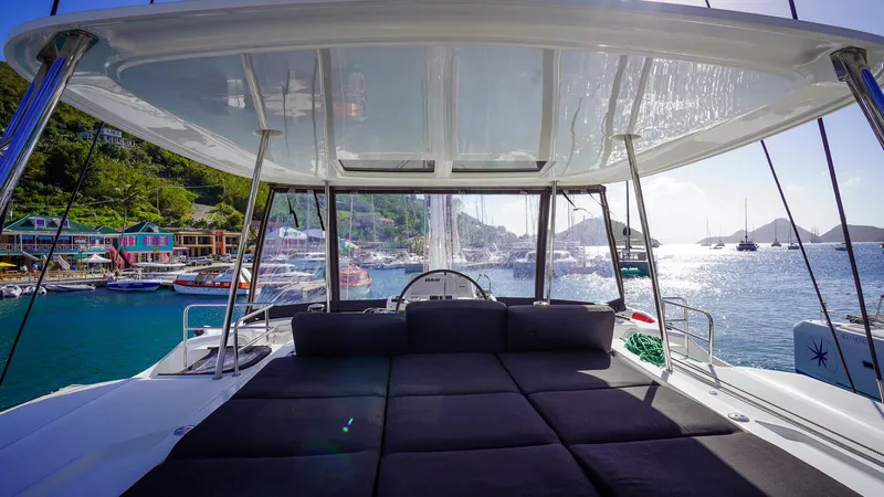 Karma Yacht Photos Pics Lagoon 50 catamaran, 2020 model, docked in a scenic marina with sunlit waters.