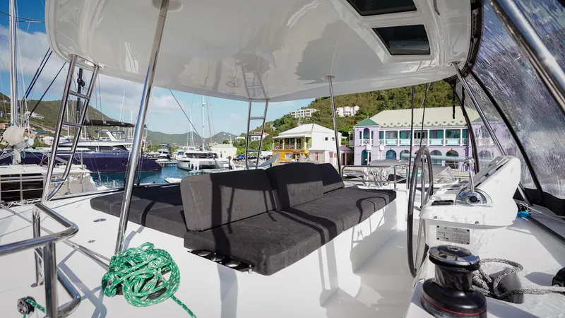 Karma Yacht Photos Pics 2020 Lagoon 50 catamaran with spacious deck and seating in a vibrant marina.