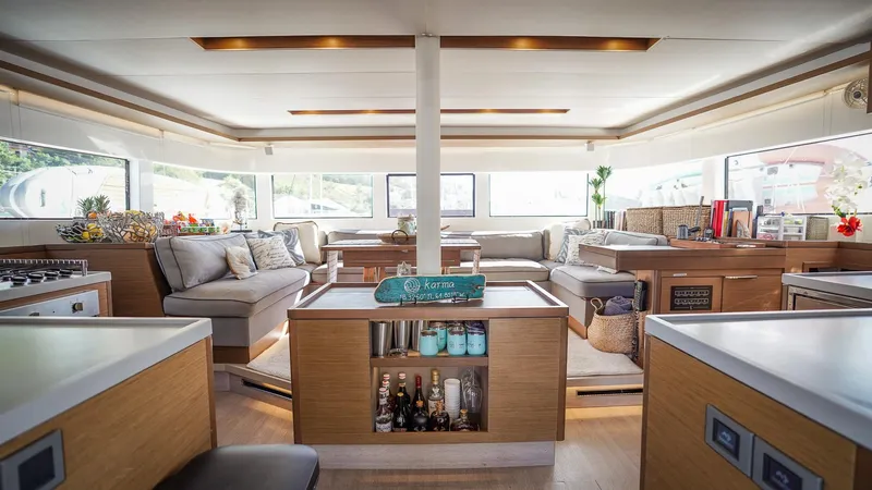Karma Yacht Photos Pics Luxurious interior of a 2020 Lagoon 50 catamaran with modern furnishings and ample natural light.