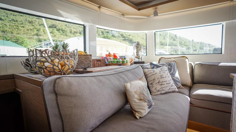 Karma Yacht Photos Pics Luxurious interior of 2020 Lagoon 50 yacht with plush seating and decorative pillows.