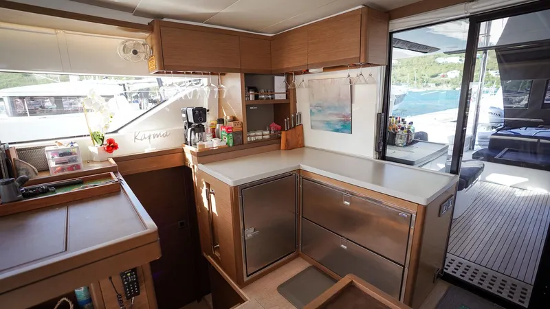 Karma Yacht Photos Pics Modern kitchen interior on 2020 Lagoon 50 yacht, featuring sleek cabinetry and ample counter space.