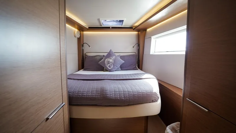 Karma Yacht Photos Pics Luxurious cabin interior of 2020 Lagoon 50 yacht with cozy bed and modern design.